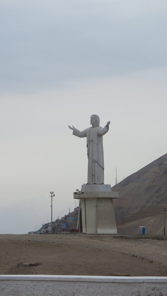 Best Places to Visit in Lima - The Cristo del Pacífico (Christ of the Pacific) statue overlooking the hills in Chorrillos, Lima, Peru.