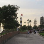 Best Places to Visit in Lima - The landmark Faro de la Marina lighthouse overlooking the cliffs in Miraflores, Lima, Peru.