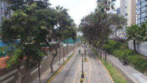 Must-see Places in Lima - A cobblestone pedestrian walkway with palm trees and vintage street lamps in the Miraflores district of Lima, Peru.