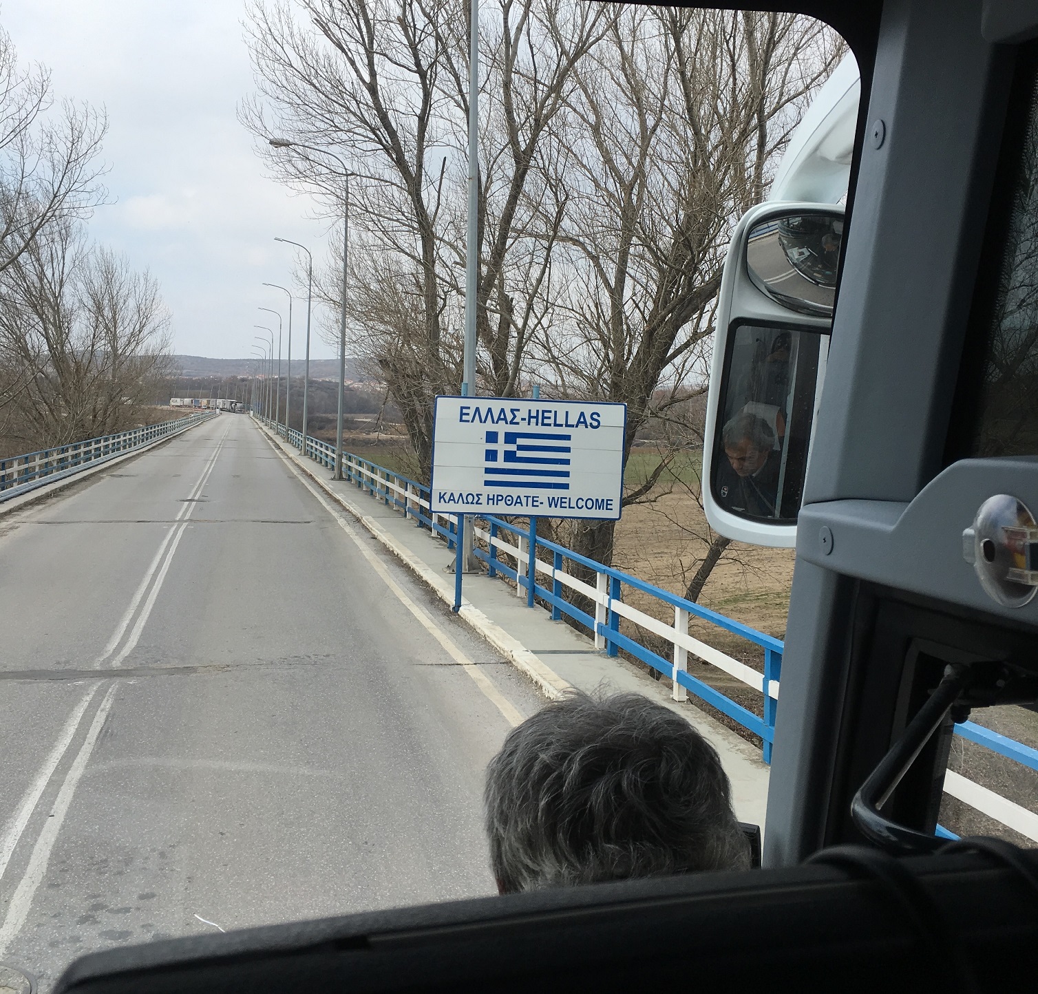 Welcome to Greece’ sign seen from a bus after crossing the border bridge.