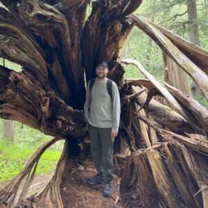 The writer standing in front of a fallen tree
