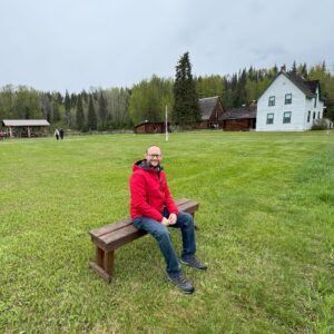 A photo of the writer with the Huble Homestead area visible in the background.