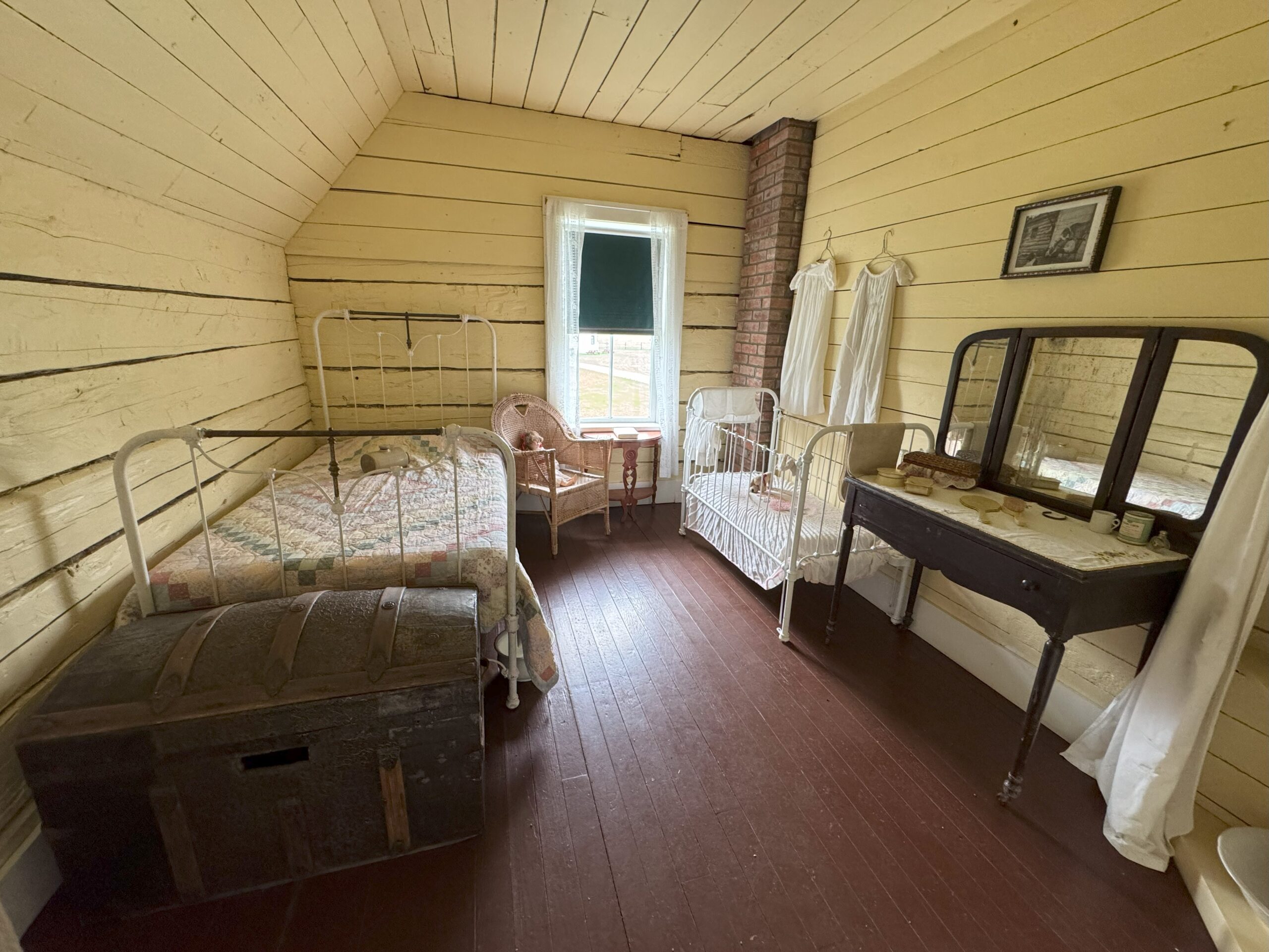 A historic bedroom belonging to Adelaide Marion (Ada), featuring a small bed, simple furnishings, and period decor.