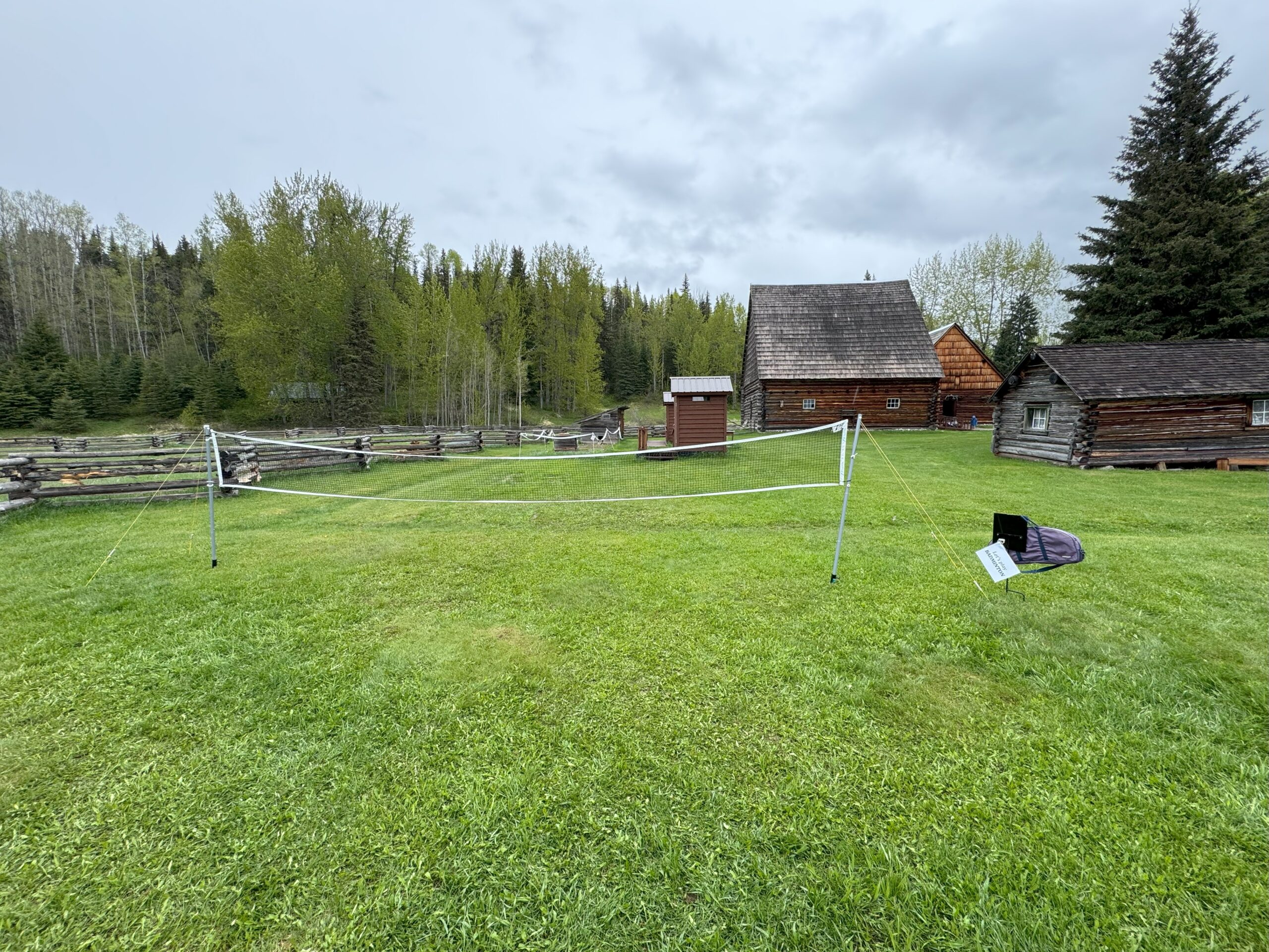 badminton court set up on the grass at Huble Homestead with net and rackets.