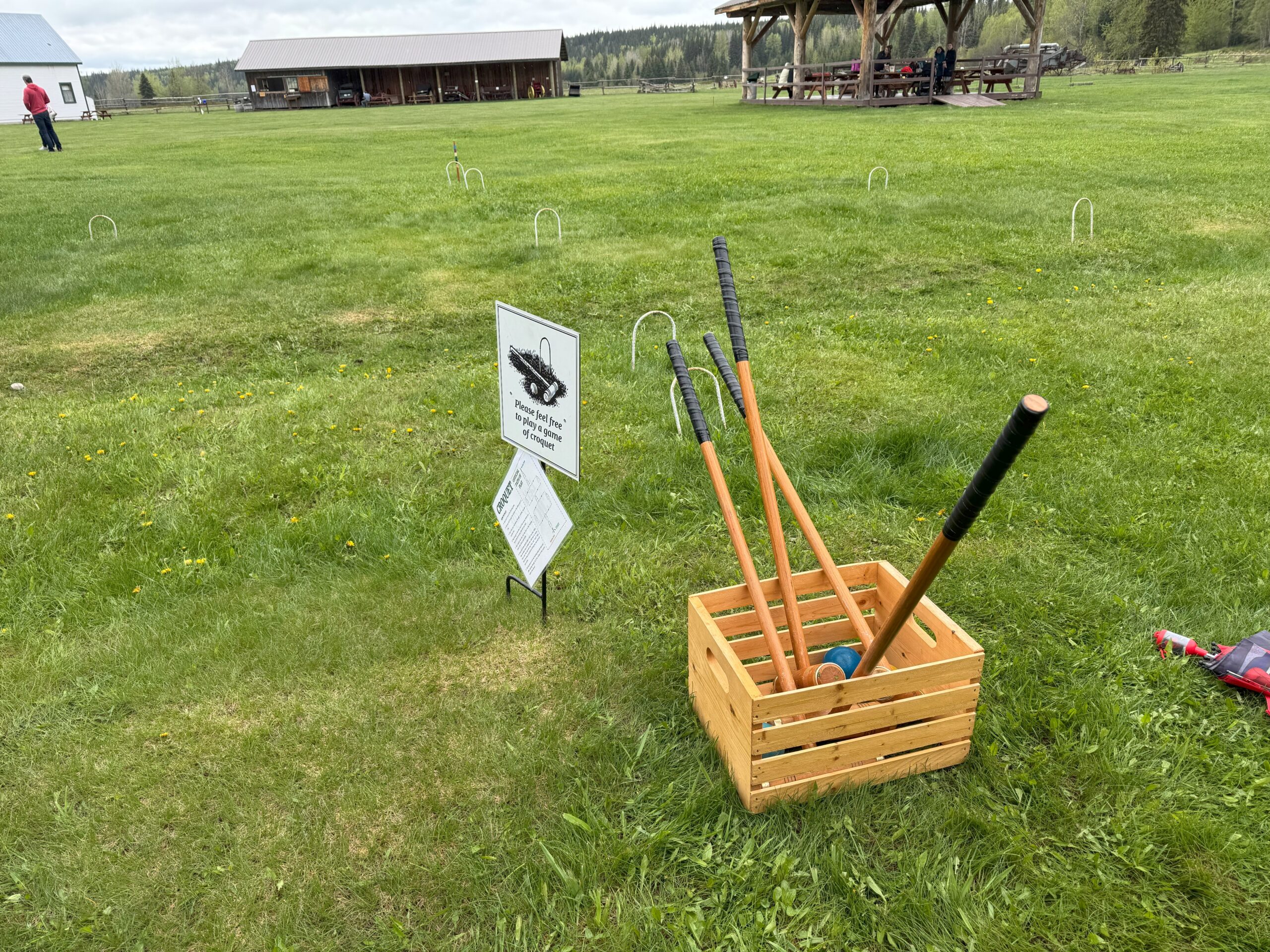 Croquet mallets, balls, and hoops arranged on the lawn at Huble Homestead.