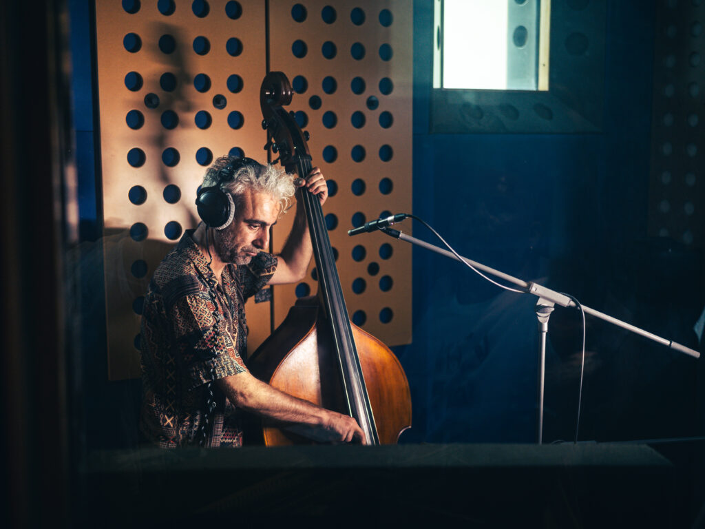 Zenith - Apostolos Sideris Apostolos Sideris plays the double bass in a recording studio, deeply focused during the Zenith jazz album session.