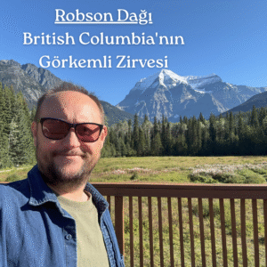 Güneşli bir günde, masmavi gökyüzünün altında Mount Robson'ın önünde bir gezginin fotoğrafı.