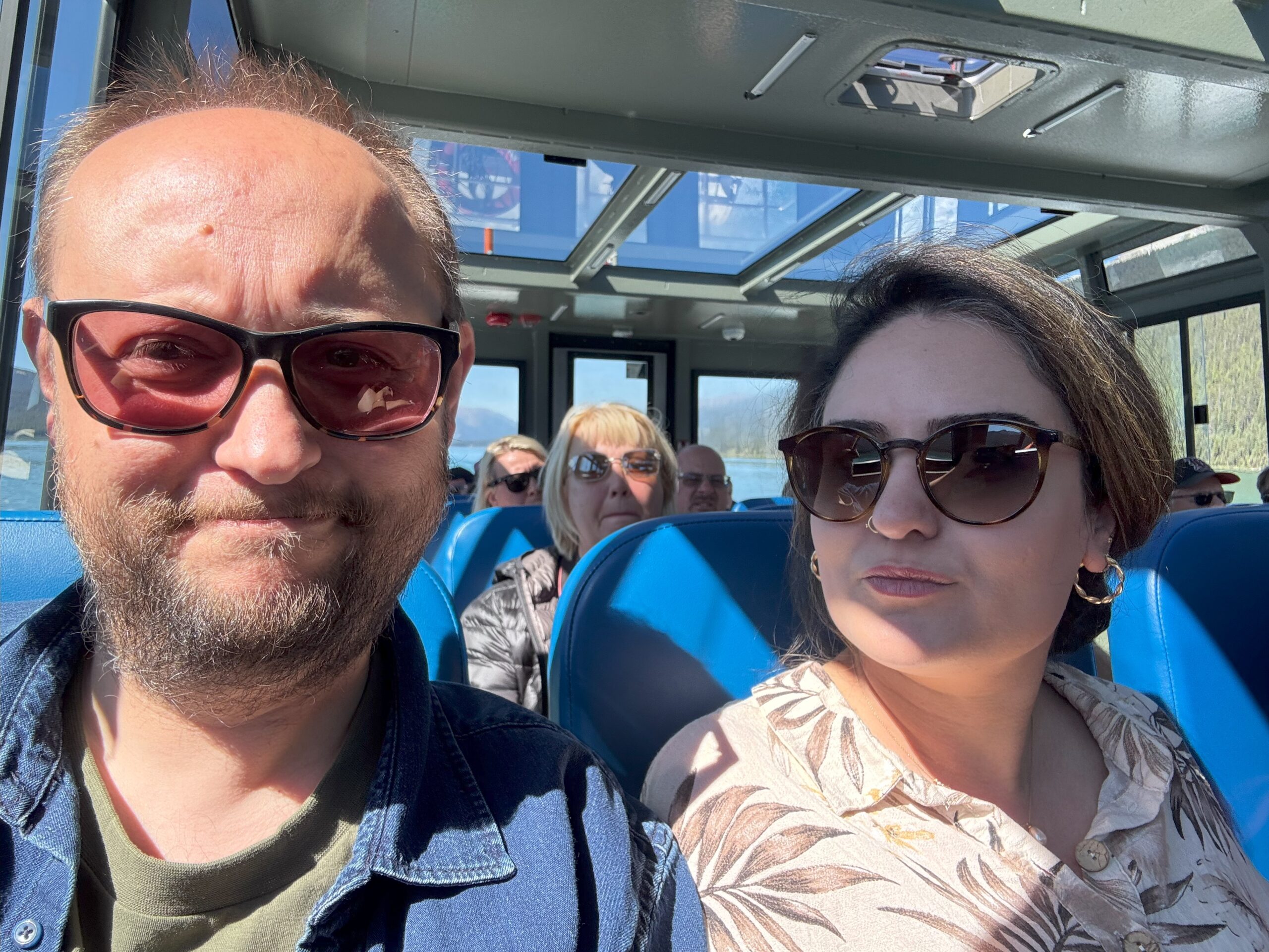 A couple takes a selfie inside the Maligne Lake tour boat.