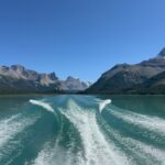 Wake of a boat on turquoise Maligne Lake with Rocky Mountains in the background, Jasper National Park, Alberta, Canada.