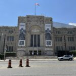 Front view of the Royal Ontario Museum in Toronto, with banners advertising the “Auschwitz. Not long ago. Not far away.” exhibition.