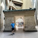 A visitor stands beside an ancient Chinese stone gate inside the Royal Ontario Museum in Toronto.