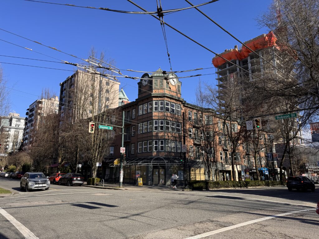 Vancouver Times Square Suites Hotel 1 The welcoming entrance of Times Square Suites Hotel in Vancouver with a classic brick facade and green awnings.