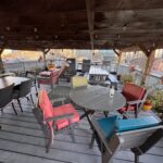 View from the rooftop patio of Times Square Suites Hotel in Vancouver’s West End, overlooking the intersection of Robson and Denman streets with city views.