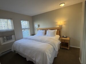 Cozy bedroom at Times Square Suites Hotel with crisp white linens and natural light.