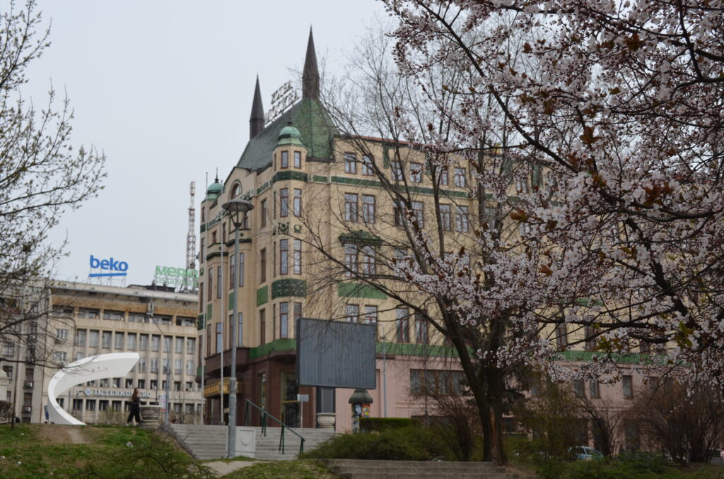 Hotel Moskva Belgrade Serbia Best time to visit Belgrade - The historic Hotel Moskva framed by blooming white spring flowers in central Belgrade, Serbia.
