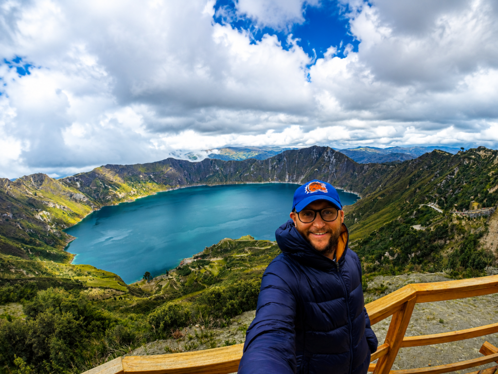 Ecuador Laguna de Quilotoa Viewpoint 1 Traveler standing at the Laguna de Quilotoa viewpoint overlooking the turquoise Quilotoa Lake crater in the Ecuadorian Andes.