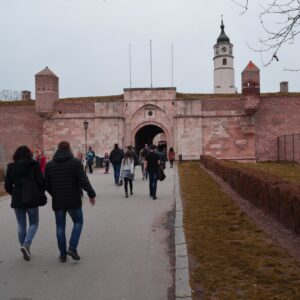 Things to do in Belgrade - Visitors walking towards the Stambol Gate and Sahat Kula clock tower at Belgrade Fortress (Kalemegdan) in Belgrade, Serbia.