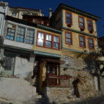 Things to do in Kavala - Narrow stone street lined with traditional Ottoman-style houses in Panagia Old Town, Kavala, Greece.