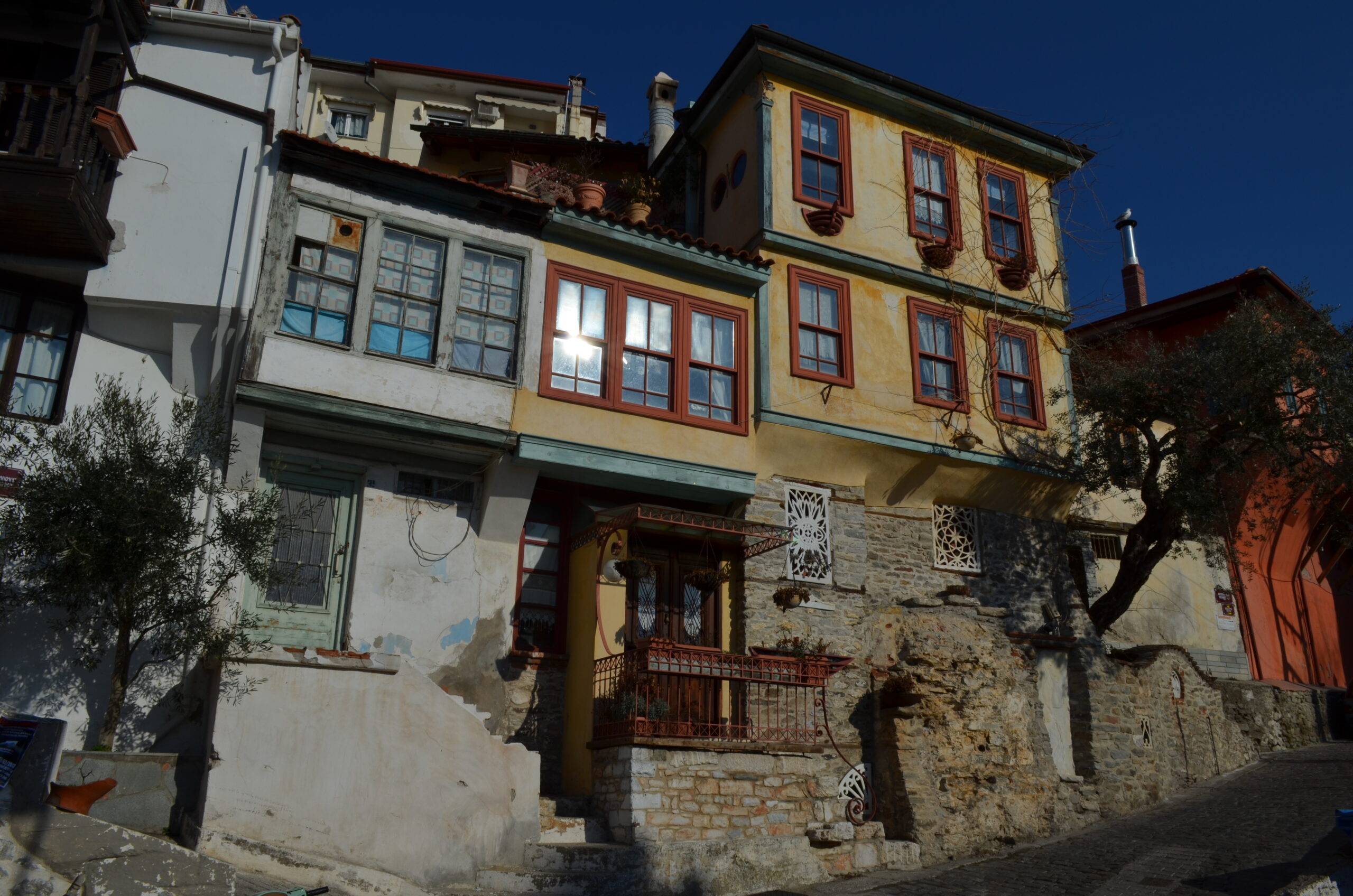 Things to do in Kavala - Narrow stone street lined with traditional Ottoman-style houses in Panagia Old Town, Kavala, Greece.