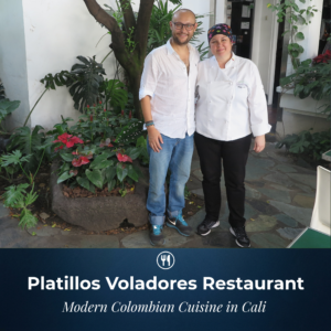 Travel blogger Ismet Ersoy standing alongside acclaimed Colombian chef Vicky Acosta in the garden courtyard of Platillos Voladores Restaurant in Cali.