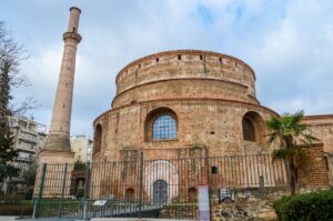 Exterior of the historic Rotunda of Thessaloniki with its circular brick structure and adjacent Ottoman minaret
