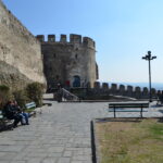 Historic Trigonio Tower in Thessaloniki's Ano Poli, with stone fortification walls, a lookout terrace, and city views.