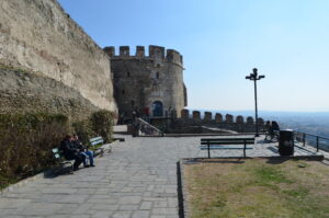Historic Trigonio Tower in Thessaloniki's Ano Poli, with stone fortification walls, a lookout terrace, and city views.